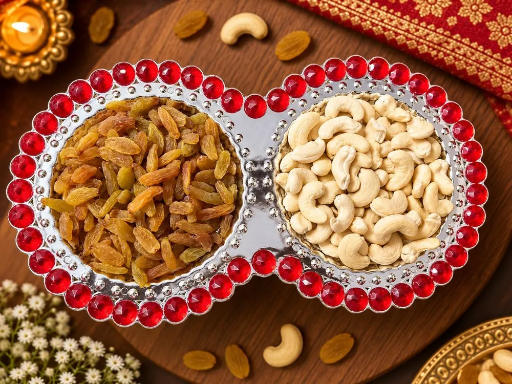 Kaju-Kishmish Thaal: golden kishmish and kaju in a jewelled two-bowl silver thaal